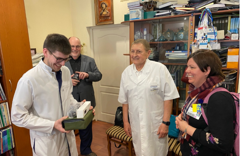 Ukrainian doctor receiving a donation from Hospital Sisters Mission Outreach