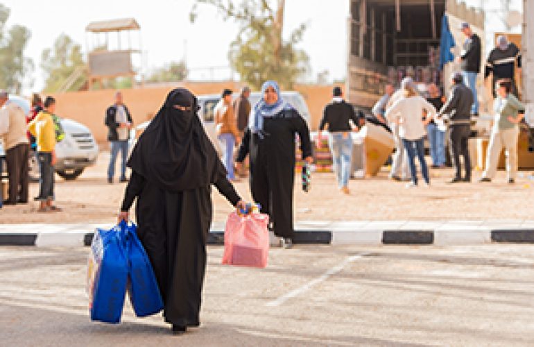 A Displaced Syrian Woman Benefits From a House Cleaning Kit for Her Large Family