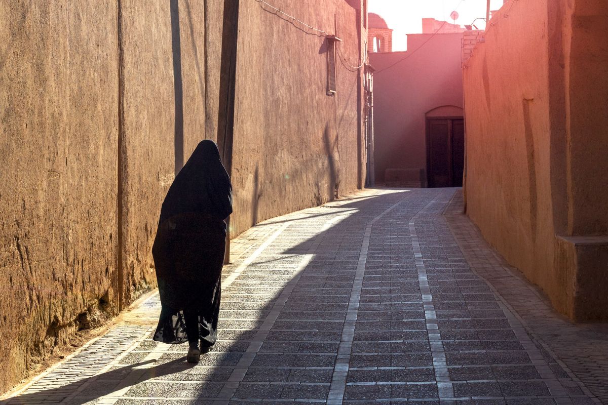 Veiled woman in street