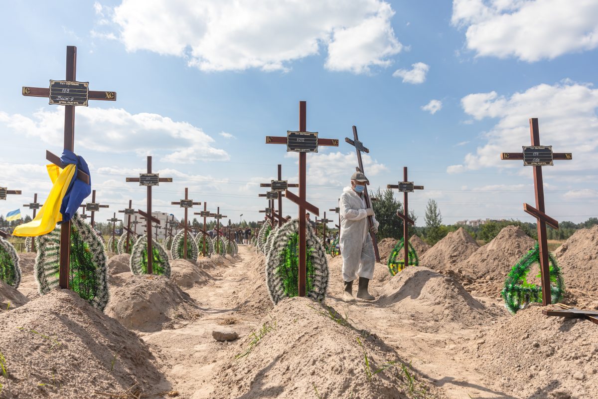 Burial of the remains of 13 unidentified and two identified people who were killed in the Bucha district. ©Mikhail Palinchak/Shutterstock.com