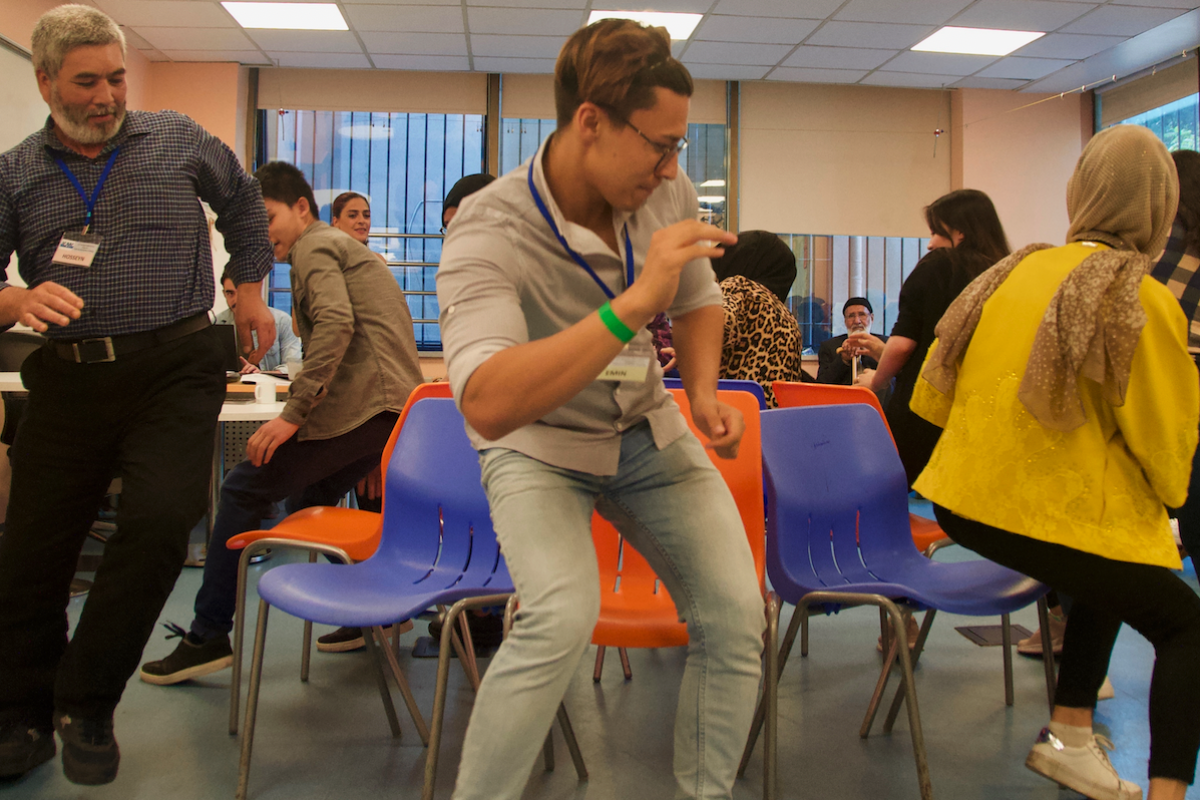 Refugees and ICMC staff take part in a Cultural Orientation session at the ICMC Resettlement Support Center (RSC) in Istanbul in 2023