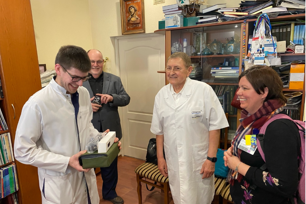 Ukrainian doctor receiving a donation from Hospital Sisters Mission Outreach