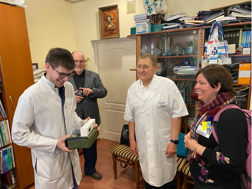 Ukrainian doctor receiving a donation from Hospital Sisters Mission Outreach