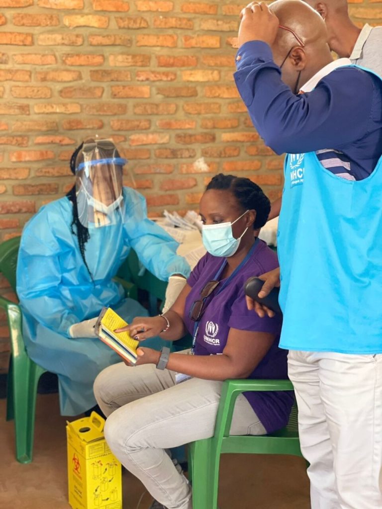 Participating in a 2020 COVID-19 vaccination drive, led by the Rwanda Ministry of Health, in the Emergency Transit Mechanism Gashora, in Bugesera, Rwanda © Maureen Muthoni Gachiri