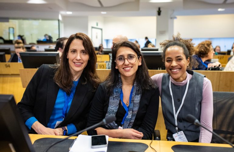 ICMC’s Gabriela Agatiello (left) & Anna Coulibaly (right) at the 2025 European Migration Forum (EMF), with Fatemeh Jailani of SINGA