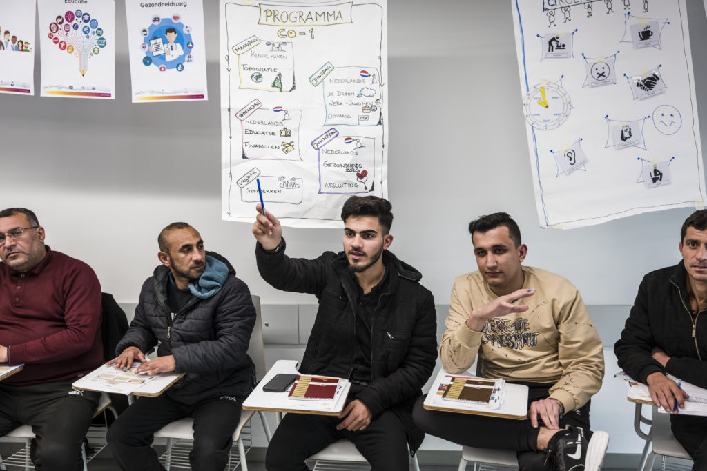 A group of refugee students participating in a Pre-Departure Orientation class at the EUAA RSF.