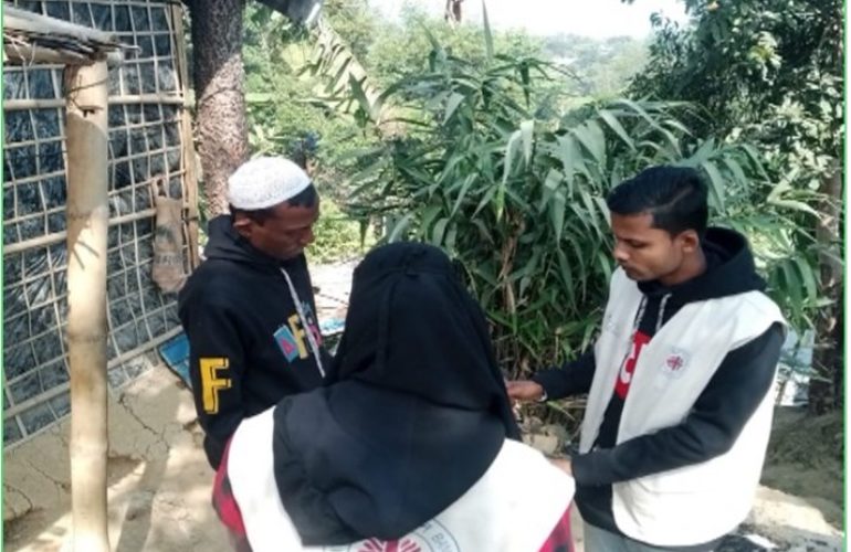 Community volunteers trained by Caritas Bangladesh conduct a trafficking awareness household visit to a Rohingya refugee family
