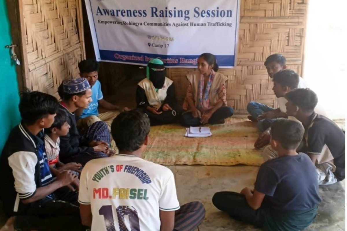 In 2025, ICMC support enabled Caritas Bangladesh to carry out 424 household visits, building awareness of human trafficking risks amongst 2,126 Rohingya refugee family members. Photo: Trained community volunteers conduct a household visit to a Rohingya family in Bangladesh.